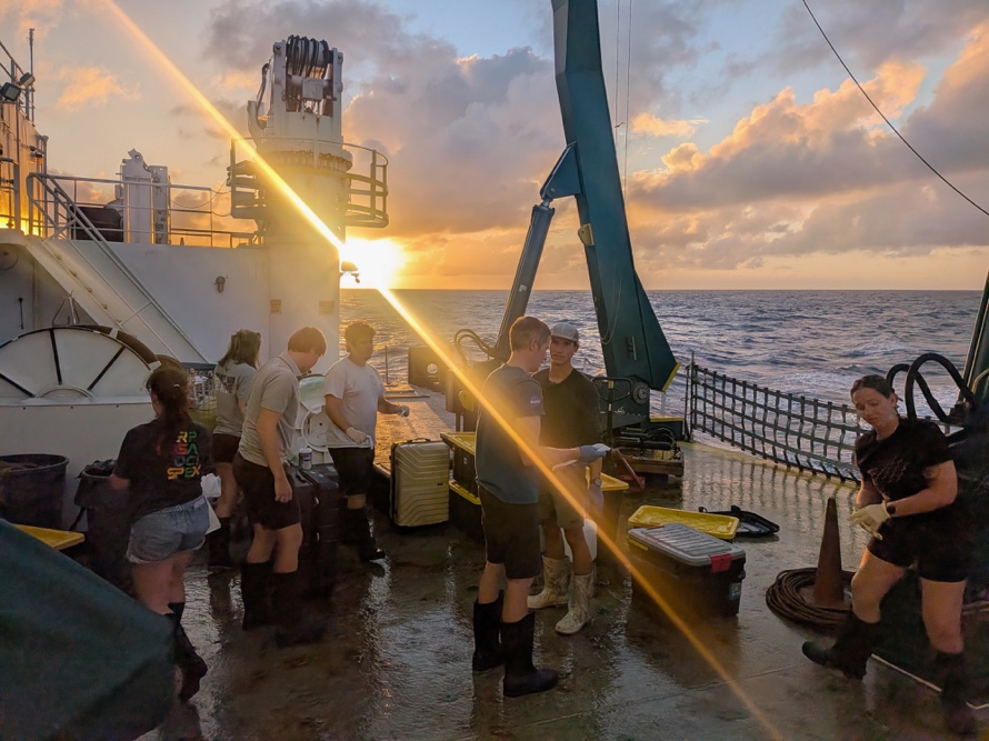 HOT-365 science team moving and cleaning supplies at sunset